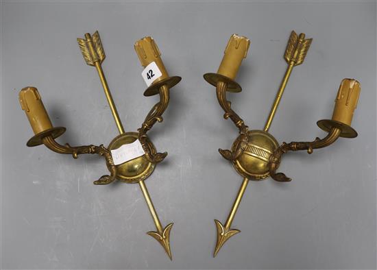 A pair of Empire style ormolu two branch wall sconces decorated with arrows length 39cm